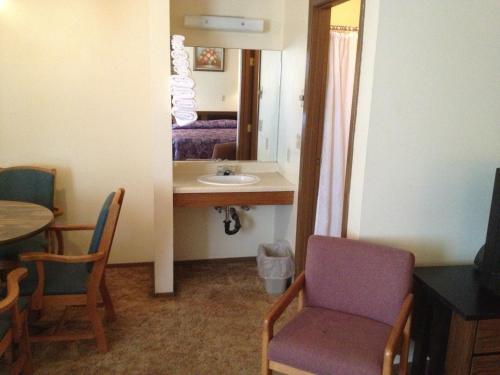 a room with a sink and a table with a chair at Budget Inn in Green River