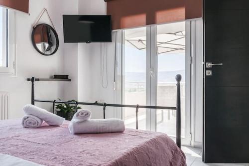 a bedroom with a bed with towels on it at Sea View Maisonette in Chania in Chania Town