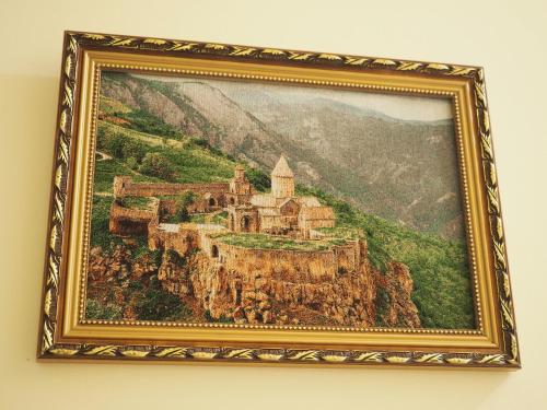 a painting of a castle on a mountain at Kirch Hotel & Restaurant in Goris