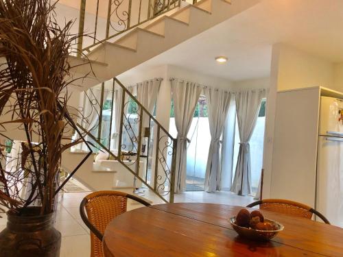 a dining room table with a bowl of fruit on it at Villa Bella Vista in Cabo Frio