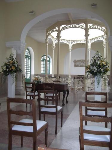 a room with a table and chairs and a piano at Hotel Termas da Curia in Curia