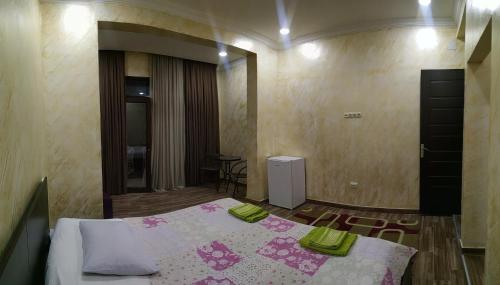 a bedroom with a bed with green towels on it at Batumi Homestay at Tamar Mephe Avenue in Makhinjauri