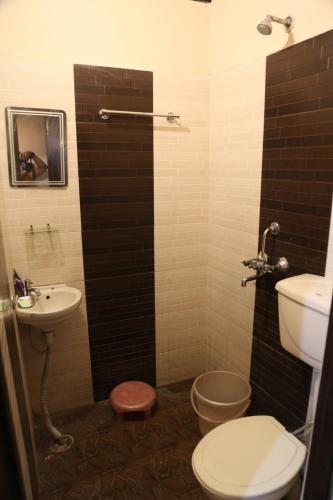 a bathroom with a toilet and a sink at Time Square Guest House in Jalandhar