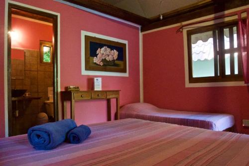 a bedroom with two beds with blue towels on them at Naturalmente Boutique Bungalows y Cocina Mediterránea in Las Lajas