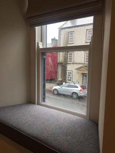 a window seat with a view of a car at Bush House Accommodation - The Diamond in Bushmills