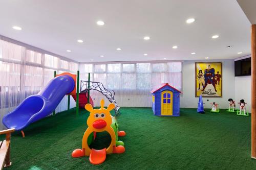 a room with a playground with a slide and play equipment at Spa Hotel Colossae Thermal in Pamukkale