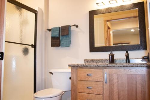 a bathroom with a sink and a mirror at Inn at the River in Wausau