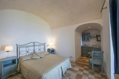 a bedroom with a bed and a bathroom with a sink at Villa Il Frantoio and Lilmar in Praiano