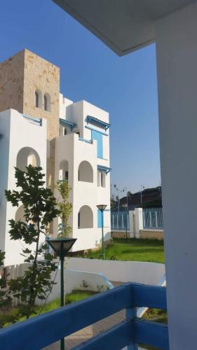 a view of a building from a balcony at Résidence Lilia Al Jabal M’diQ in M'diq