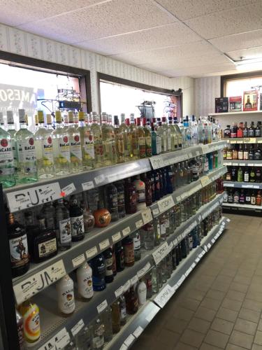a store aisle filled with lots of bottles of alcohol at Best Budget Inn Owatonna in Owatonna