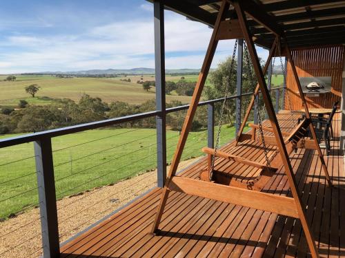 a view from the porch of a house with a swing at Barossa Pavilions & Glasshouse in Lyndoch