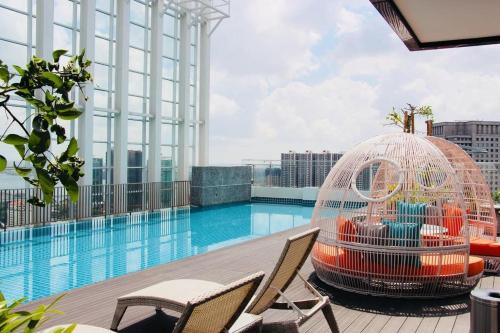 a bird cage sitting next to a swimming pool at Suasana JB at JB Center Luxury Modern & Rustic 1BR Apt for Bussiness,Vacation trips in Johor Bahru