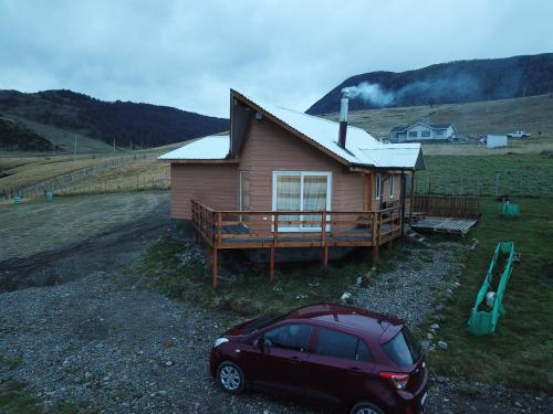 a small house with a car parked in front of it at Ventisca Sur in Coihaique