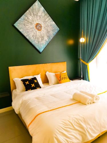 a bedroom with a bed with white sheets and pillows at Legoland D'PRISTINE Apartment By TGP in Nusajaya
