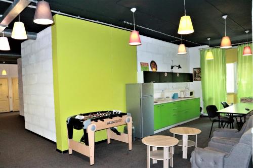 a kitchen with green walls and a table and chairs at Happy Hostel Kiev in Kyiv