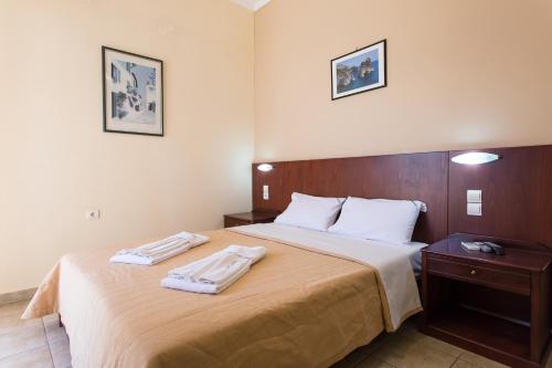 A bed or beds in a room at Glaros Hotel