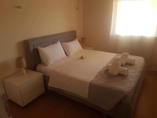a bedroom with a bed with two teddy bears on it at Villa Xani in Himare