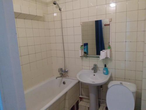 a bathroom with a sink and a toilet and a tub at Apartment Khimshiashvili 9 in Batumi