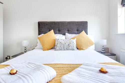 a bedroom with a white bed with two towels on it at Westmorland House in Tamworth