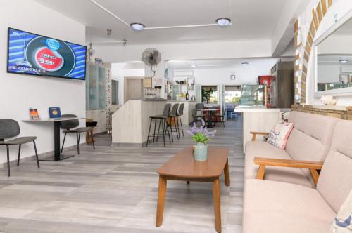 a lobby of a store with couches and a table at Pavlos Place in Antiparos Town