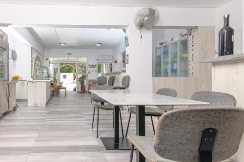 a dining room with tables and chairs at Pavlos Place in Antiparos Town