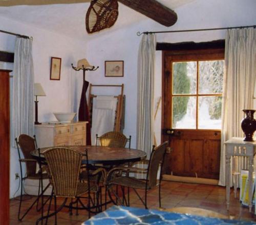une salle à manger avec une table et des chaises et une fenêtre dans l'établissement La Source à Bonnieux en Luberon, à Bonnieux