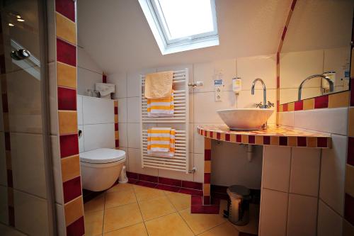 a bathroom with a sink and a toilet at Gasthof Löwen, Heitersheim in Heitersheim