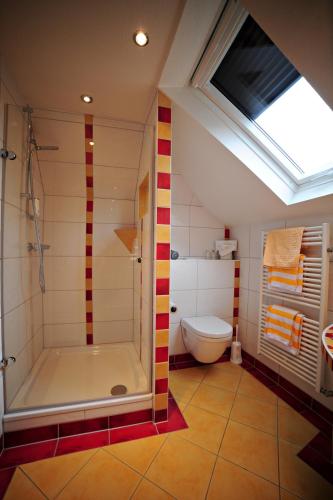 a bathroom with a shower and a toilet at Gasthof Löwen, Heitersheim in Heitersheim