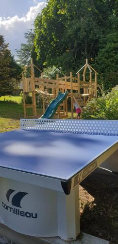 a playground with a slide on top of a table at Cosy Er Lann Gîte Cèdre in Val Couesnon