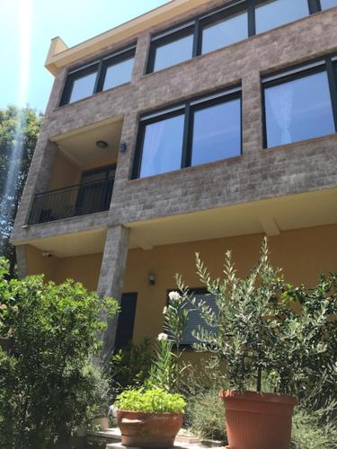 a building with windows and plants in front of it at Villa Lili in Kotor