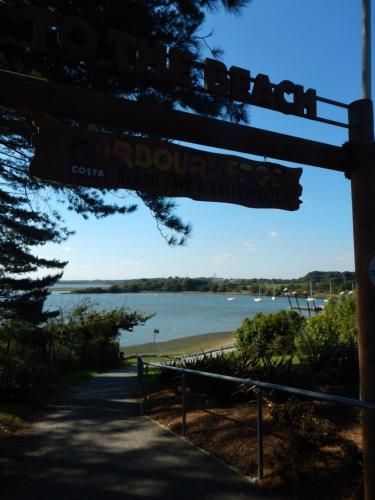a street sign with a view of a beach at Pine Ridge 59 Rockley Park Poole with sea view sleeps six in Poole