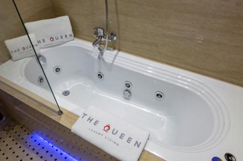 a bath tub in a bathroom with two towels at The Queen Luxury Apartments - Villa Carlotta in Luxembourg