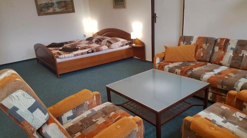 a living room with a couch and a bed at Apartmán Nové Hrady in Nové Hrady
