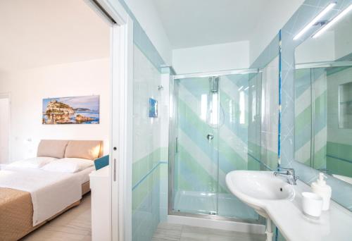 a bathroom with a sink and a shower and a bed at B&B La Gioia in Ischia