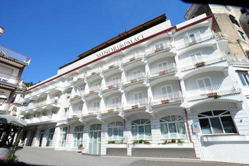 a large white building with windows and balconies at Minori Palace in Minori