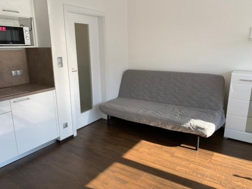 a living room with a couch and a microwave at Residence Nad Vltavou in Prague