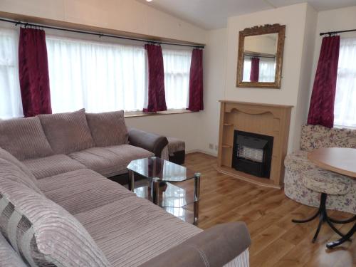 a living room with a couch and a fireplace at Domki nad Wartą in Wierzchlas
