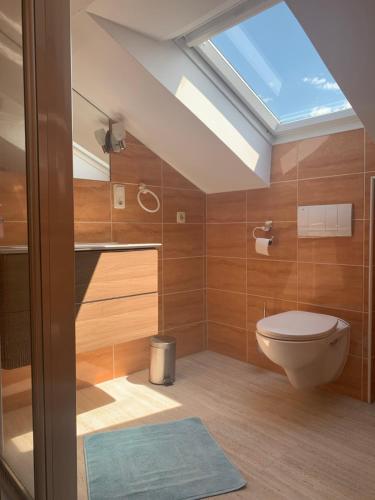 a bathroom with a toilet and a skylight at Windhör in Saxen