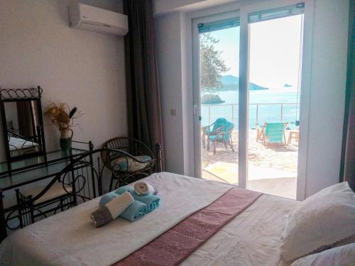 a bedroom with a bed with a view of the ocean at Sea La Vie Apt. in Paleokastritsa