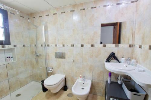 a bathroom with a toilet and a sink and a shower at APARTMENT GOLDEN costa teguise in Costa Teguise