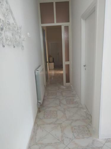a hallway with a tile floor in a room at TO & GI in Striano