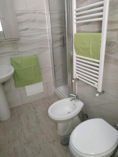 a bathroom with a toilet and a sink and a shower at TO & GI in Striano