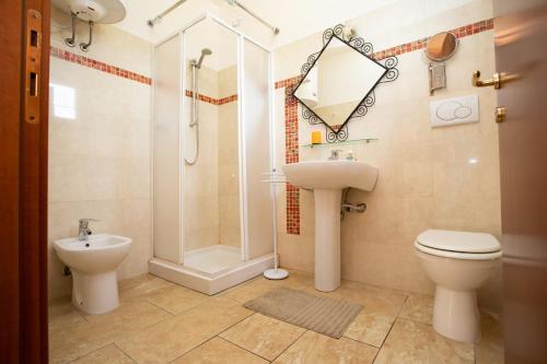 a bathroom with a toilet and a sink and a shower at Villa Liburnia in Livorno