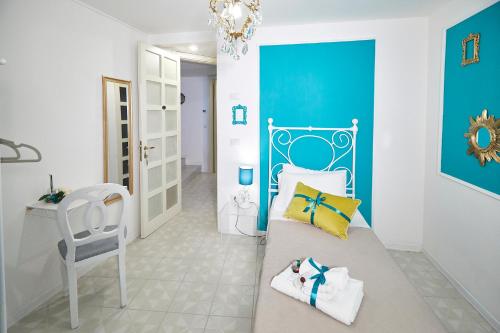 a bedroom with a bed and a chair in a room at Il Piccolo Principe Affittacamere in Foligno