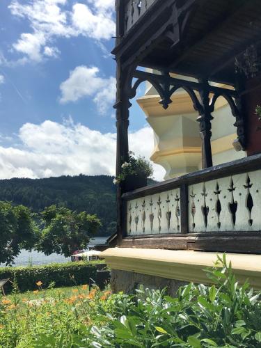 a balcony of a house with a view of the water at Villa Streintz in Millstatt