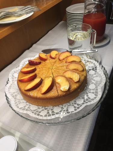 a cake on a glass plate on a table at Garni La Vara in Corvara in Badia