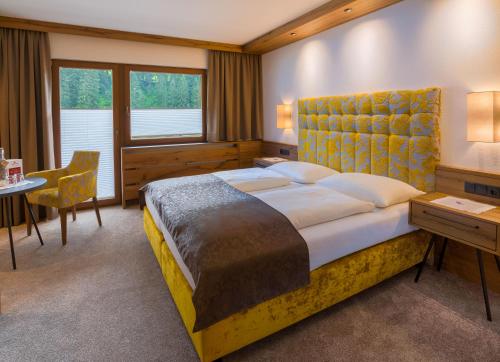 Ένα ή περισσότερα κρεβάτια σε δωμάτιο στο Hotel-Garni Jakober