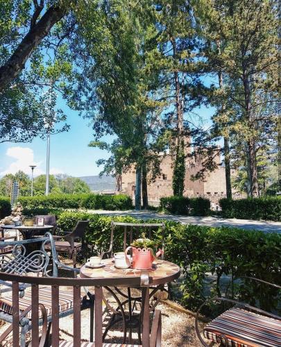 a patio with a table and chairs and trees at Hotel Xabier in Javier