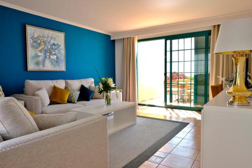 a living room with blue walls and a couch at Aldiana Club Fuerteventura in Morro del Jable