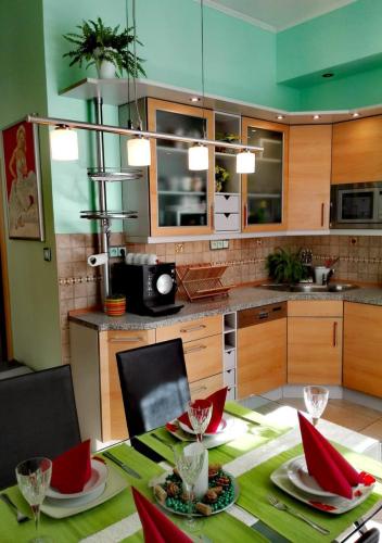 a kitchen with a table with red chairs and a table sidx sidx sidx at Apartment Villa Frank in Mariánské Lázně